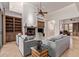 Bright living room with built in shelving, fireplace, and neutral color palette at 8689 E Krail St, Scottsdale, AZ 85250