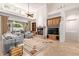 Spacious living room with a fireplace, large windows, and access to the outdoor patio at 8689 E Krail St, Scottsdale, AZ 85250