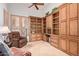 Home office featuring wood built-in shelving, desk area and cozy leather recliner at 8689 E Krail St, Scottsdale, AZ 85250
