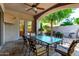 Charming covered patio featuring a glass-top table, chairs, and a decorative archway with lush landscaping at 8689 E Krail St, Scottsdale, AZ 85250