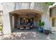 Relaxing covered patio with pavers, fan, dining table, chairs, and potted plants at 8689 E Krail St, Scottsdale, AZ 85250
