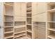 Organized walk-in closet with shelving and storage drawers at 8689 E Krail St, Scottsdale, AZ 85250