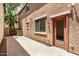 A cozy backyard featuring a concrete patio and access door at 89 E Palomino Dr, Gilbert, AZ 85296