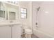 Bathroom featuring a shower-tub combo, vanity, toilet, window, and bright lighting fixtures at 89 E Palomino Dr, Gilbert, AZ 85296
