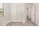 Bedroom featuring a closet with sliding doors, wood-look floors, and neutral color palette at 89 E Palomino Dr, Gilbert, AZ 85296