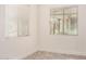 Bright bedroom featuring neutral walls, wood-look floors, and large windows with bright natural light at 89 E Palomino Dr, Gilbert, AZ 85296