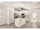 Open concept kitchen with white cabinets, stainless steel appliances, a large island and wood-look floors at 89 E Palomino Dr, Gilbert, AZ 85296
