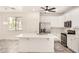 Modern kitchen with white cabinets, stainless steel appliances, an island with seating, and wood-look floors at 89 E Palomino Dr, Gilbert, AZ 85296