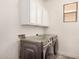 A laundry room featuring a window, cabinets, and a washer and dryer at 89 E Palomino Dr, Gilbert, AZ 85296