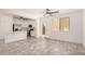 Open-concept living area featuring modern flooring, white trim, an open floorplan, and a modern kitchen at 89 E Palomino Dr, Gilbert, AZ 85296