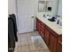 Well-lit bathroom features a double vanity, tile floors, and a large mirror at 920 E Devonshire Ave # 2031, Phoenix, AZ 85014