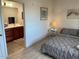 Comfortable bedroom adjacent to the bathroom with a bed, lamp, and tasteful decor, creating a relaxing atmosphere at 920 E Devonshire Ave # 2031, Phoenix, AZ 85014