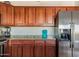 A kitchen with wood cabinets, granite countertops, and stainless steel appliances at 920 E Devonshire Ave # 2031, Phoenix, AZ 85014