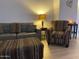 Well-lit living room showcasing a sofa, accent chair, ottoman, and contemporary furnishings at 920 E Devonshire Ave # 2031, Phoenix, AZ 85014