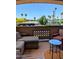 Comfortable patio seating area with a table and views of palm trees and neighborhood scenery at 920 E Devonshire Ave # 2031, Phoenix, AZ 85014