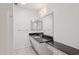 Bathroom with dark granite countertops and framed mirrors at 9802 N Balboa Dr, Sun City, AZ 85351