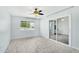 Bright room features tile flooring, a ceiling fan, a sliding glass door, and a window at 9802 N Balboa Dr, Sun City, AZ 85351
