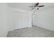 A bedroom featuring tile flooring, a ceiling fan, and closet doors at 9802 N Balboa Dr, Sun City, AZ 85351