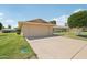 Residential house with a spacious driveway and well-maintained lawn, showcasing suburban charm at 9802 N Balboa Dr, Sun City, AZ 85351