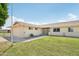 Street view of a single-story home featuring a well-kept lawn and appealing architectural details at 9802 N Balboa Dr, Sun City, AZ 85351