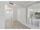 Hallway featuring tile flooring, a door to the exterior, and access to other rooms at 9802 N Balboa Dr, Sun City, AZ 85351