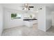 Bright kitchen features tile flooring, white cabinetry, black counters, and a ceiling fan at 9802 N Balboa Dr, Sun City, AZ 85351