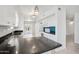Bright kitchen featuring white cabinets, dark countertops, stainless steel sink, and modern lighting fixtures at 9802 N Balboa Dr, Sun City, AZ 85351