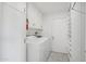 Bright laundry room with a washer, dryer, storage cabinets and shelving at 9802 N Balboa Dr, Sun City, AZ 85351