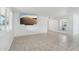 Clean and modern living room boasting tile floors, a mounted TV, and ample natural light at 9802 N Balboa Dr, Sun City, AZ 85351