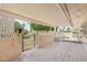 Spacious covered patio with tiled flooring, block wall, and metal gate offering a private outdoor living space at 9802 N Balboa Dr, Sun City, AZ 85351