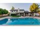 This home has a large backyard with a pool, covered patio, lush lawn, mature trees and outdoor seating at 9921 E Doubletree Ranch Rd, Scottsdale, AZ 85258