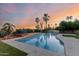 Backyard oasis with a sparkling pool, mature palm trees, and relaxing lounge area at 9921 E Doubletree Ranch Rd, Scottsdale, AZ 85258