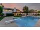 Luxurious backyard featuring a pool with diving board, patio area, and manicured landscaping at 9921 E Doubletree Ranch Rd, Scottsdale, AZ 85258