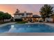 Inviting backyard with a sparkling pool, lush lawn, and an outdoor dining area at 9921 E Doubletree Ranch Rd, Scottsdale, AZ 85258