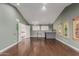 Bonus room with hardwood floors, neutral walls, and wet bar at 9921 E Doubletree Ranch Rd, Scottsdale, AZ 85258