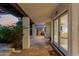 Covered patio featuring tiled flooring, elegant columns, and an entrance to the house at 9921 E Doubletree Ranch Rd, Scottsdale, AZ 85258