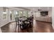 Formal dining room with dark wood table, french doors to the yard and dark wood floors at 9921 E Doubletree Ranch Rd, Scottsdale, AZ 85258