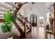 Grand foyer featuring hardwood floors, high ceilings, staircase, and a custom front door at 9921 E Doubletree Ranch Rd, Scottsdale, AZ 85258