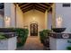 Elegant entryway featuring a custom door, decorative potted plants, and stone pathway at 9921 E Doubletree Ranch Rd, Scottsdale, AZ 85258