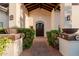 Inviting entryway highlighting custom door, decorative plants, and a welcoming pathway at 9921 E Doubletree Ranch Rd, Scottsdale, AZ 85258