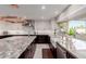 Bright kitchen featuring granite countertops, modern stainless steel appliances, and white and dark wood cabinets at 9921 E Doubletree Ranch Rd, Scottsdale, AZ 85258