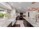 Open kitchen view featuring granite countertops, white cabinets, stainless steel appliances and an open view to living spaces at 9921 E Doubletree Ranch Rd, Scottsdale, AZ 85258