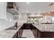 Modern kitchen with granite countertops, white cabinets, stainless steel appliances and view to backyard at 9921 E Doubletree Ranch Rd, Scottsdale, AZ 85258