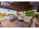 This outdoor living area has multiple seating areas, a pool, a pergola, and desert landscaping at 9921 E Doubletree Ranch Rd, Scottsdale, AZ 85258
