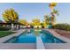 The backyard pool features a diving board, brick coping, grassy area, a patio and outdoor dining at 9921 E Doubletree Ranch Rd, Scottsdale, AZ 85258