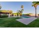 This backyard features a pool, diving board, a grassy area, and an outdoor dining area at 9921 E Doubletree Ranch Rd, Scottsdale, AZ 85258