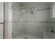 Modern shower with glass door, tiled walls, and built-in shelving at 9921 E Doubletree Ranch Rd, Scottsdale, AZ 85258