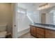 Bright bathroom featuring a tub and shower combination and a vanity with a dark countertop at 9939 W Southgate Ave, Tolleson, AZ 85353