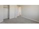 Neutral bedroom with carpeted floors, a closet, and white trim at 9939 W Southgate Ave, Tolleson, AZ 85353