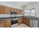 Modern kitchen with stainless steel appliances, granite countertops, and a window offering a view of the outdoors at 9939 W Southgate Ave, Tolleson, AZ 85353